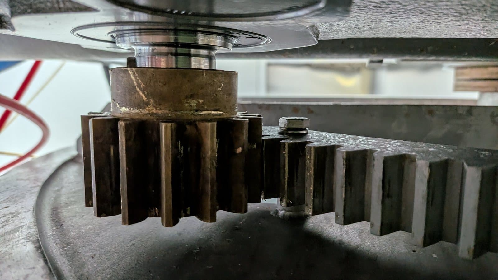 Close inspection of a worn bronze drive gear against sprocket teeth